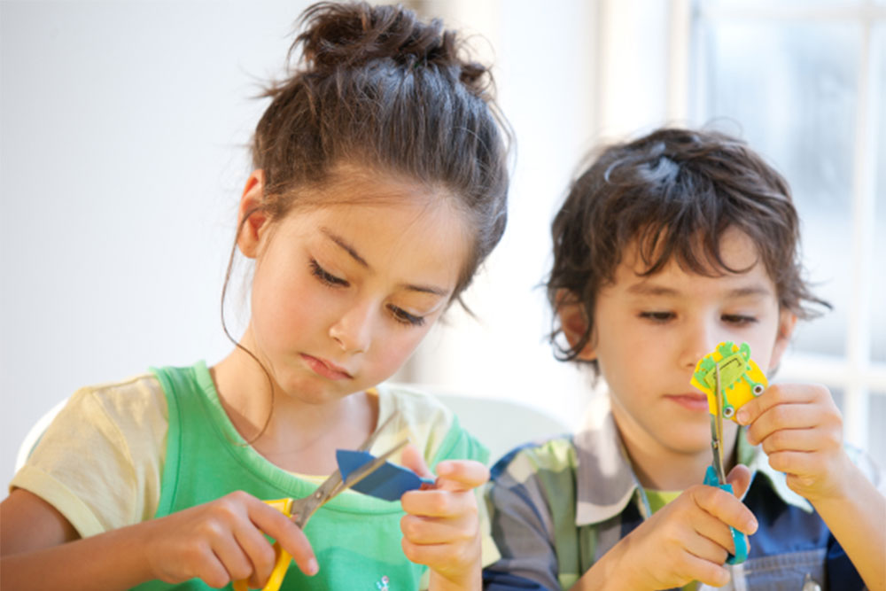 A young girl and boy doing crafts