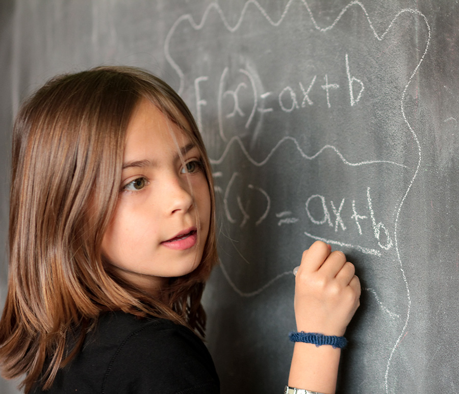 Child writing and equation with chalk